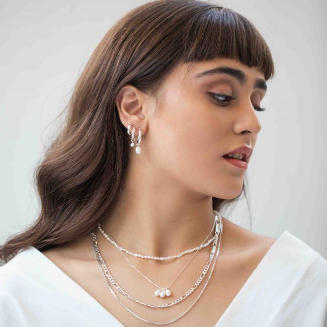 Stunning earrings from our silver collection. A pair of 13 mm hoop earrings made of real silver with a lovely real pearl hanging from them. Easy and comfortable to wear, special and full of style. Shower with the earrings and there is a lifetime warranty.
